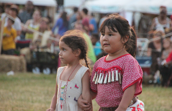 two little girls dancing at a pow wow