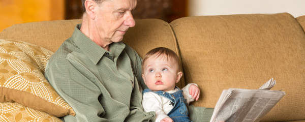 baby and grandfather reading the news